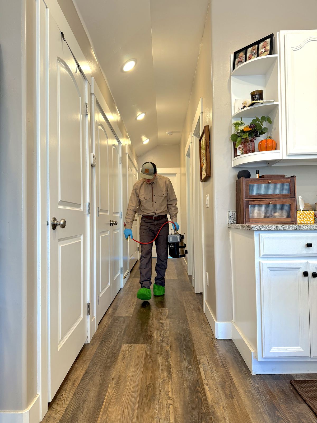 Triple Crown technician treating baseboards during an interior visit